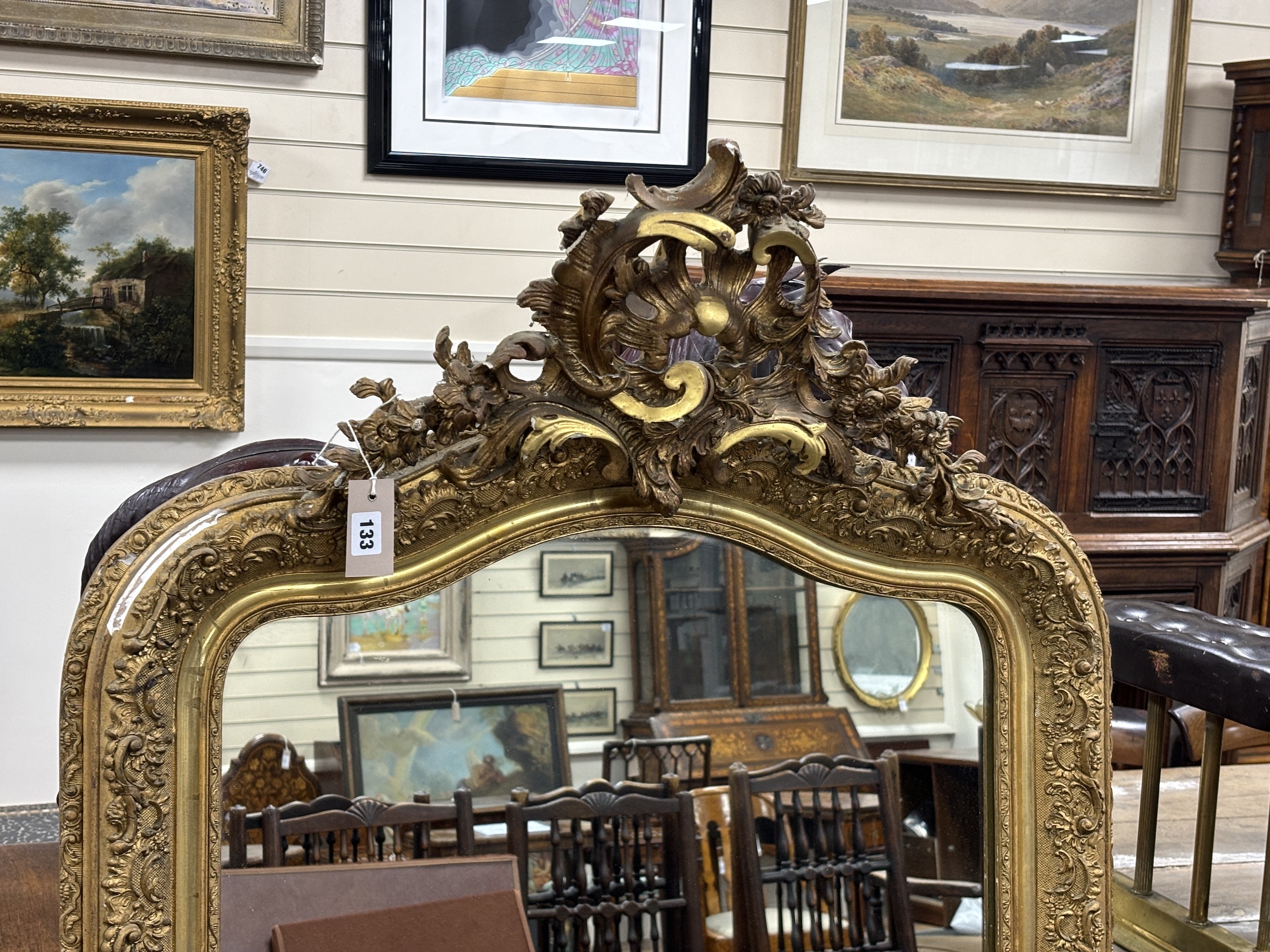 A 19th century French giltwood and composition overmantel mirror with pierced scroll pediment, width 86cm, height 158cm